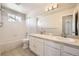 Bright bathroom featuring double sinks, a large mirror, and a shower-over-tub combination with tile surround at 10037 Idalia St, Commerce City, CO 80022