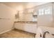 Relaxing bathroom featuring a double sink vanity, and a soaking tub at 10037 Idalia St, Commerce City, CO 80022