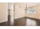 Open dining area with dark wood floors, chandelier, and natural light at 10037 Idalia St, Commerce City, CO 80022