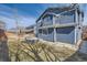 Exterior of home's back facade with hardiplank siding, a stone firepit and fenced yard at 10037 Idalia St, Commerce City, CO 80022