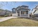 Lovely two-story home featuring a covered porch, landscaped yard, and a spacious driveway at 10037 Idalia St, Commerce City, CO 80022