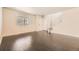 Bright living room with hardwood floors, a large window, and a view of the staircase at 10037 Idalia St, Commerce City, CO 80022