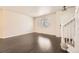 Inviting living room features dark wood floors, window and white staircase at 10037 Idalia St, Commerce City, CO 80022