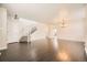 Spacious living room with hardwood floors, staircase, and ample natural light at 10037 Idalia St, Commerce City, CO 80022
