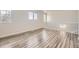 An upstairs loft area with wood laminate flooring and natural light at 10037 Idalia St, Commerce City, CO 80022