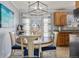 Dining area with modern light fixture, wood floors, and view to exterior at 1277 W 135Th Pl, Broomfield, CO 80234