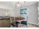Bright dining room with wood floors, stylish decor, and round table illuminated by a modern light fixture at 1277 W 135Th Pl, Broomfield, CO 80234