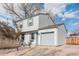 View of home with gray siding, a one-car garage, xeriscaped front yard, and driveway at 1277 W 135Th Pl, Broomfield, CO 80234