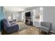 Cozy living room features a stone fireplace, wood flooring, and neutral color palette at 1277 W 135Th Pl, Broomfield, CO 80234