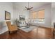 Living room with hardwood floors, large windows, and ceiling fan at 9557 Juniper Way, Arvada, CO 80007