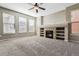 Living room with fireplace, built-in shelves, hardwood and carpeted floors at 21646 E Stroll Ave, Parker, CO 80138