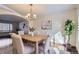 Dining room with hardwood floors, a wooden table and chairs, and a view to the living room at 7212 S Acoma St, Littleton, CO 80120