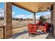 Covered back porch with ample seating offers a serene view of the surrounding landscape at 8131 S Coolidge Way, Aurora, CO 80016