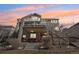 Spacious backyard featuring a multi-level deck and patio perfect for entertaining or relaxing under a colorful sunset sky at 8131 S Coolidge Way, Aurora, CO 80016