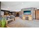 Spacious finished basement area with bar, wine room, television, and access to other areas at 8131 S Coolidge Way, Aurora, CO 80016