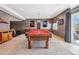 Finished basement featuring a red pool table, concrete walls, a window, and gym equipment at 8131 S Coolidge Way, Aurora, CO 80016