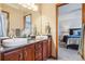 Primary bathroom boasts double sinks, a large mirror, and views into the main bedroom at 8131 S Coolidge Way, Aurora, CO 80016