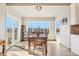 Bright dining room with large windows, hardwood floors, and sliding door to patio at 8131 S Coolidge Way, Aurora, CO 80016