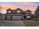 Charming two-story home with a three-car garage and well-maintained front yard under a beautiful pink and orange sky at 8131 S Coolidge Way, Aurora, CO 80016