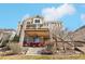 Multi-level home with an inviting outdoor patio space with brick columns and comfortable seating at 8131 S Coolidge Way, Aurora, CO 80016