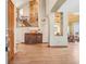 Grand foyer with hardwood floors, a wooden staircase, and an ornate cabinet, opening to a dining area at 8131 S Coolidge Way, Aurora, CO 80016