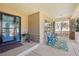 Cozy front porch with blue chairs and views of the neighborhood, adjacent to a blue front door at 8131 S Coolidge Way, Aurora, CO 80016