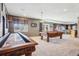 Spacious game room offers a pool table, shuffleboard, and unique wall textures for a fun retreat at 8131 S Coolidge Way, Aurora, CO 80016