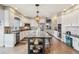 Spacious kitchen with white cabinets, stainless appliances, granite counters and large island at 8131 S Coolidge Way, Aurora, CO 80016