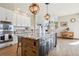 Gourmet kitchen island featuring pendant lights, granite countertops, and stainless steel appliances at 8131 S Coolidge Way, Aurora, CO 80016