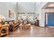 Inviting living room featuring hardwood floors, a vaulted ceiling, natural light, and comfortable leather seating at 8131 S Coolidge Way, Aurora, CO 80016