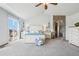 Bright main bedroom boasts vaulted ceiling and access to an ensuite bathroom with stone archway at 8131 S Coolidge Way, Aurora, CO 80016