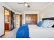 Bedroom with a wood sliding door to a bathroom and spacious closet featuring a modern ceiling fan at 8131 S Coolidge Way, Aurora, CO 80016