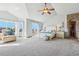 Bright main bedroom boasts vaulted ceiling, sitting area, and access to a private balcony at 8131 S Coolidge Way, Aurora, CO 80016