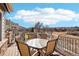 Outdoor patio featuring a dining table set with seating for six and railing with a wooded view at 8131 S Coolidge Way, Aurora, CO 80016