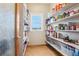 Walk-in pantry featuring built-in shelving at 8131 S Coolidge Way, Aurora, CO 80016
