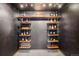 Custom wine room with unique shelving to display wine bottles against a dark textured wall at 8131 S Coolidge Way, Aurora, CO 80016
