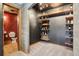 Finished basement wine room has custom wine storage rack and access to a nearby bathroom at 8131 S Coolidge Way, Aurora, CO 80016