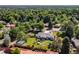 Aerial view of a ranch-style home featuring a spacious yard and lush, mature trees at 2125 Rangeview Ln, Longmont, CO 80501