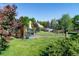 Lush backyard featuring a seating area and well-maintained landscaping and mature trees at 2125 Rangeview Ln, Longmont, CO 80501