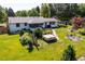 Aerial view of the expansive backyard featuring lush lawn, hot tub, patio, and fire pit at 2125 Rangeview Ln, Longmont, CO 80501
