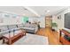 Open basement with a sectional sofa, home gym equipment, and ample space for various activities at 2125 Rangeview Ln, Longmont, CO 80501