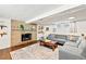 Inviting basement has a brick fireplace, a comfortable sectional sofa, and dark hardwood flooring at 2125 Rangeview Ln, Longmont, CO 80501