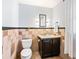 Charming half bathroom showcases decorative tile, a vanity with storage, and an elegant mirror at 2125 Rangeview Ln, Longmont, CO 80501