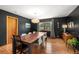 Elegant dining room with hardwood floors, a bold accent wall, and a large wooden dining table at 2125 Rangeview Ln, Longmont, CO 80501