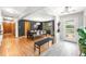 Modern dining room featuring hardwood floors, black accent wall, and contemporary lighting at 2125 Rangeview Ln, Longmont, CO 80501