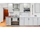 Bright kitchen features white cabinets, stainless steel appliances, and butcher block countertops at 2125 Rangeview Ln, Longmont, CO 80501