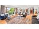 Cozy living room with large windows, stylish decor, and seamless transition to the kitchen at 2125 Rangeview Ln, Longmont, CO 80501