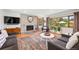 Inviting living room featuring a stone fireplace, ample natural light, and comfortable seating at 2125 Rangeview Ln, Longmont, CO 80501