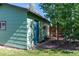 Exterior view of a shed in a backyard showing mature trees and a small bench at 2125 Rangeview Ln, Longmont, CO 80501