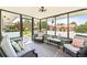 Relaxing sunroom with ample windows, comfortable seating, and views of the backyard at 2125 Rangeview Ln, Longmont, CO 80501